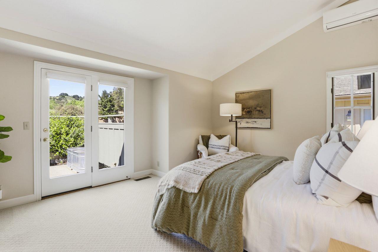 25381 Markham Lane Salinas, CA 93908 - Photo 29 of 47 a bedroom with a balcony a bed and a painting on the wall