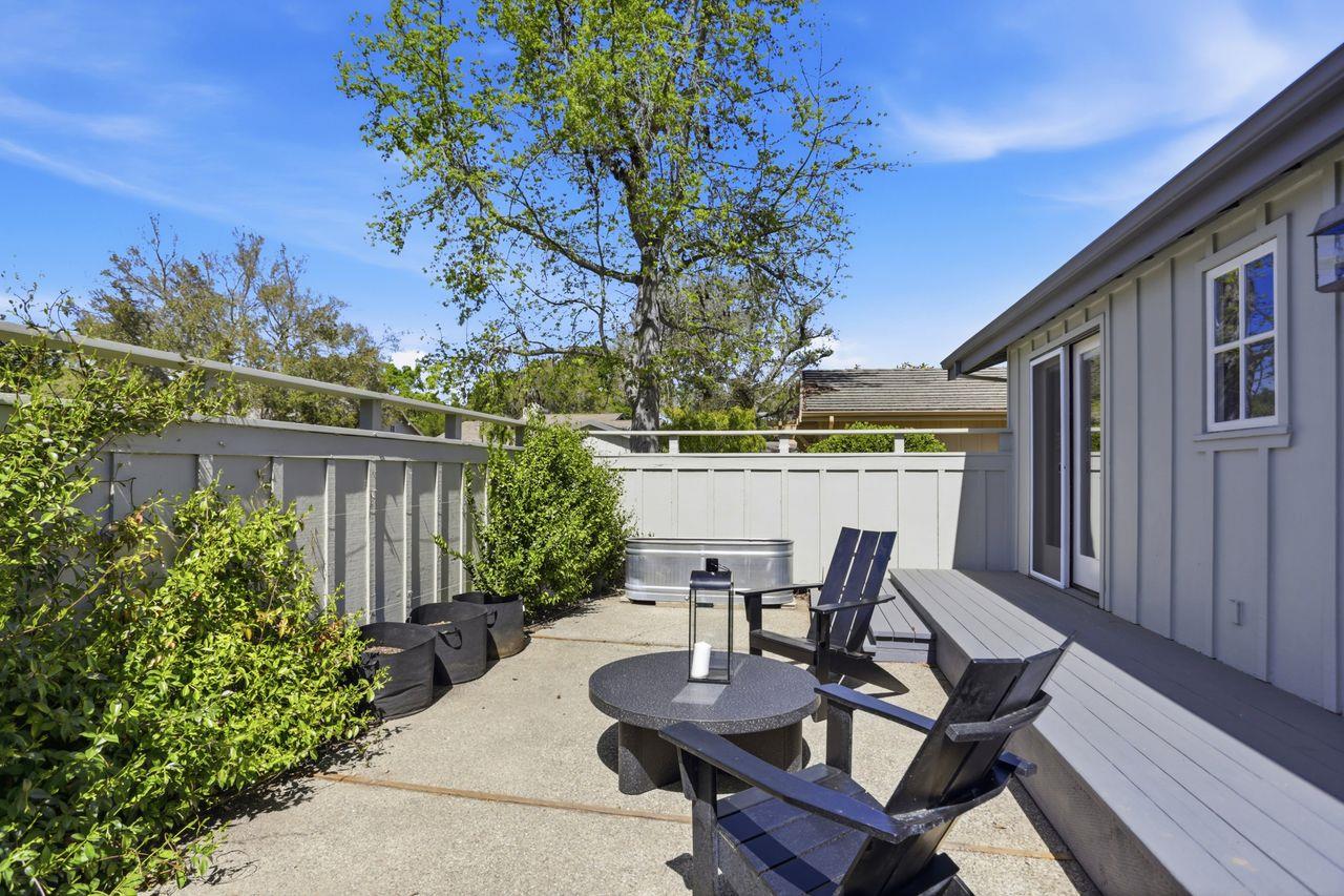 25381 Markham Lane Salinas, CA 93908 - Photo 31 of 47 a view of a patio with table and chairs and potted plants with wooden floor and fence