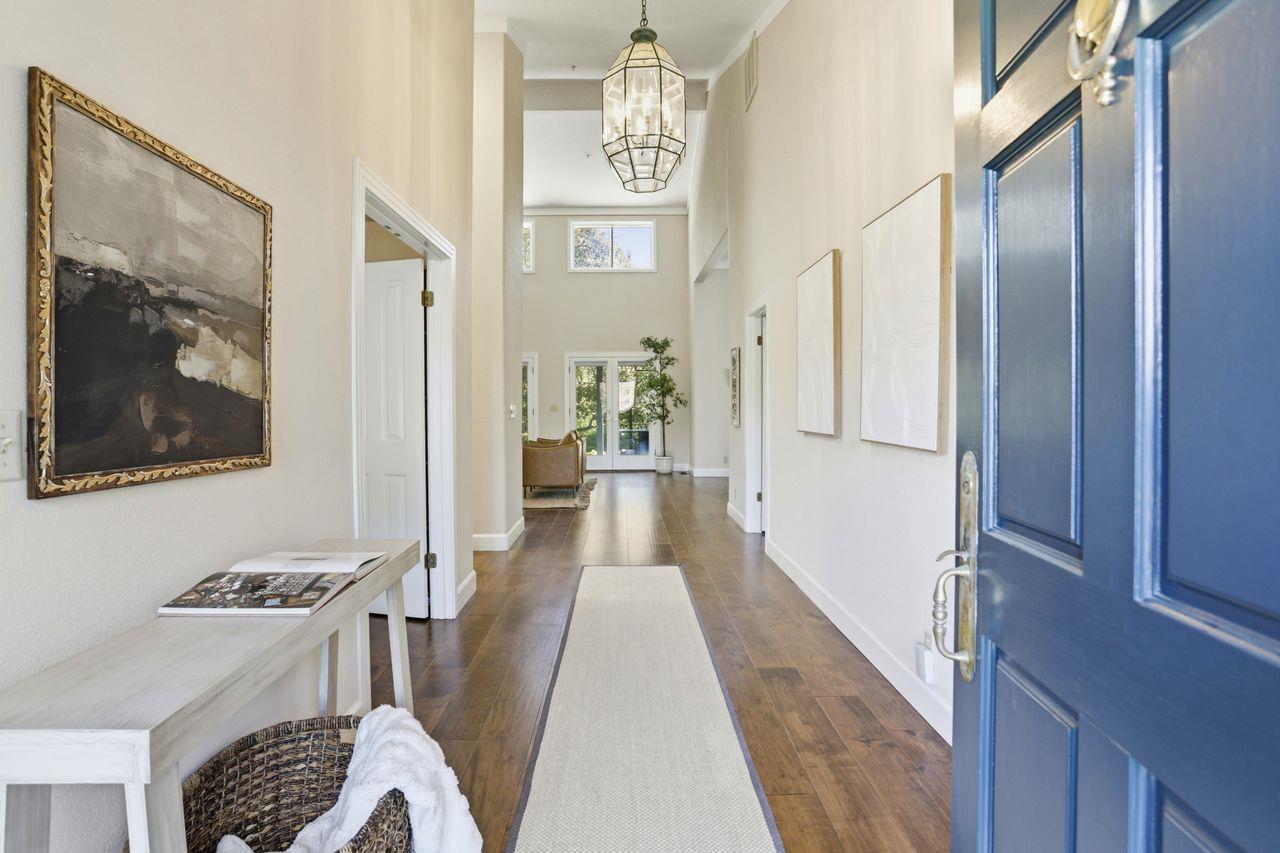 25381 Markham Lane Salinas, CA 93908 - Photo 7 of 47 a view of a hallway with wooden floor and furniture