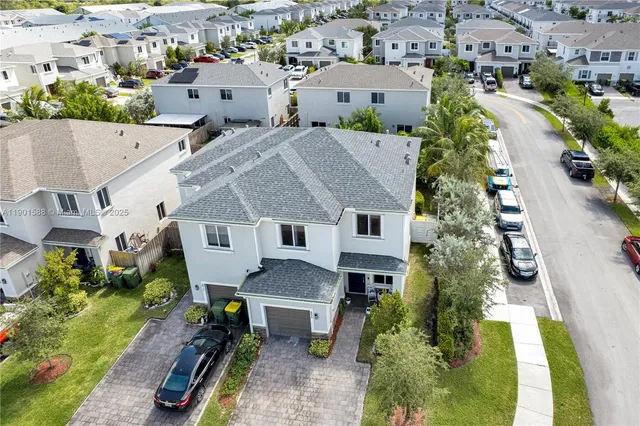 an aerial view of a house with a yard