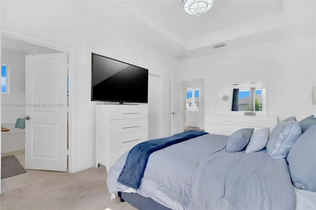 a bedroom with a bed and a flat screen tv