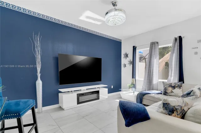 a living room with furniture and a flat screen tv