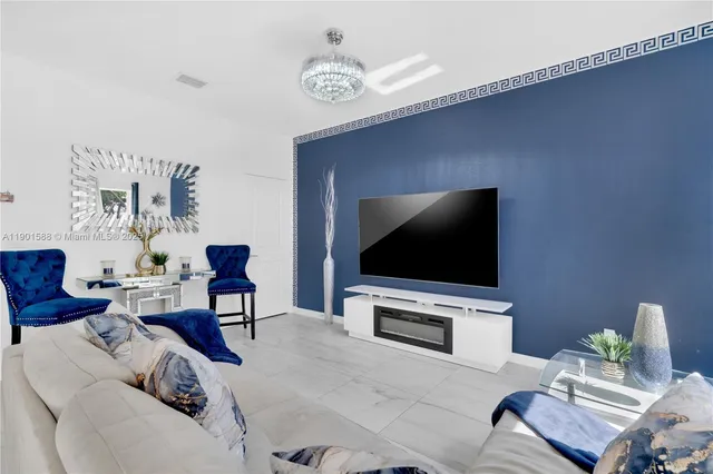 a living room with furniture and a flat screen tv