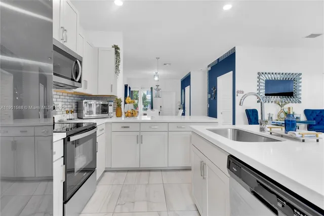 a kitchen with a sink stove and cabinets