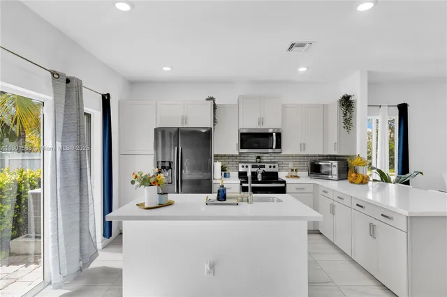 a kitchen with counter top space cabinets and stainless steel appliances