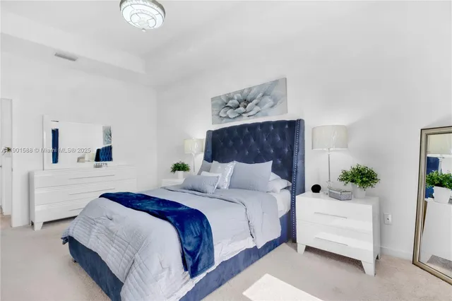 a bedroom with a large bed and a couch