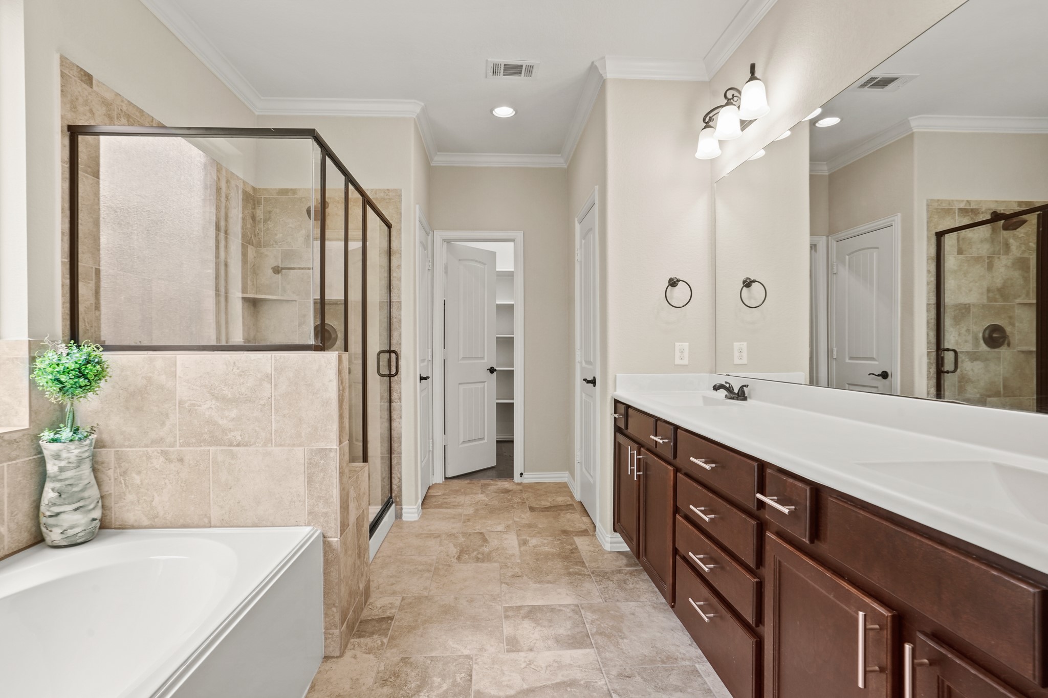 3414 Satton Ranch Lane Fulshear, TX 77441 - Photo 10 of 25 a spacious bathroom with a double vanity sink a large mirror and shower