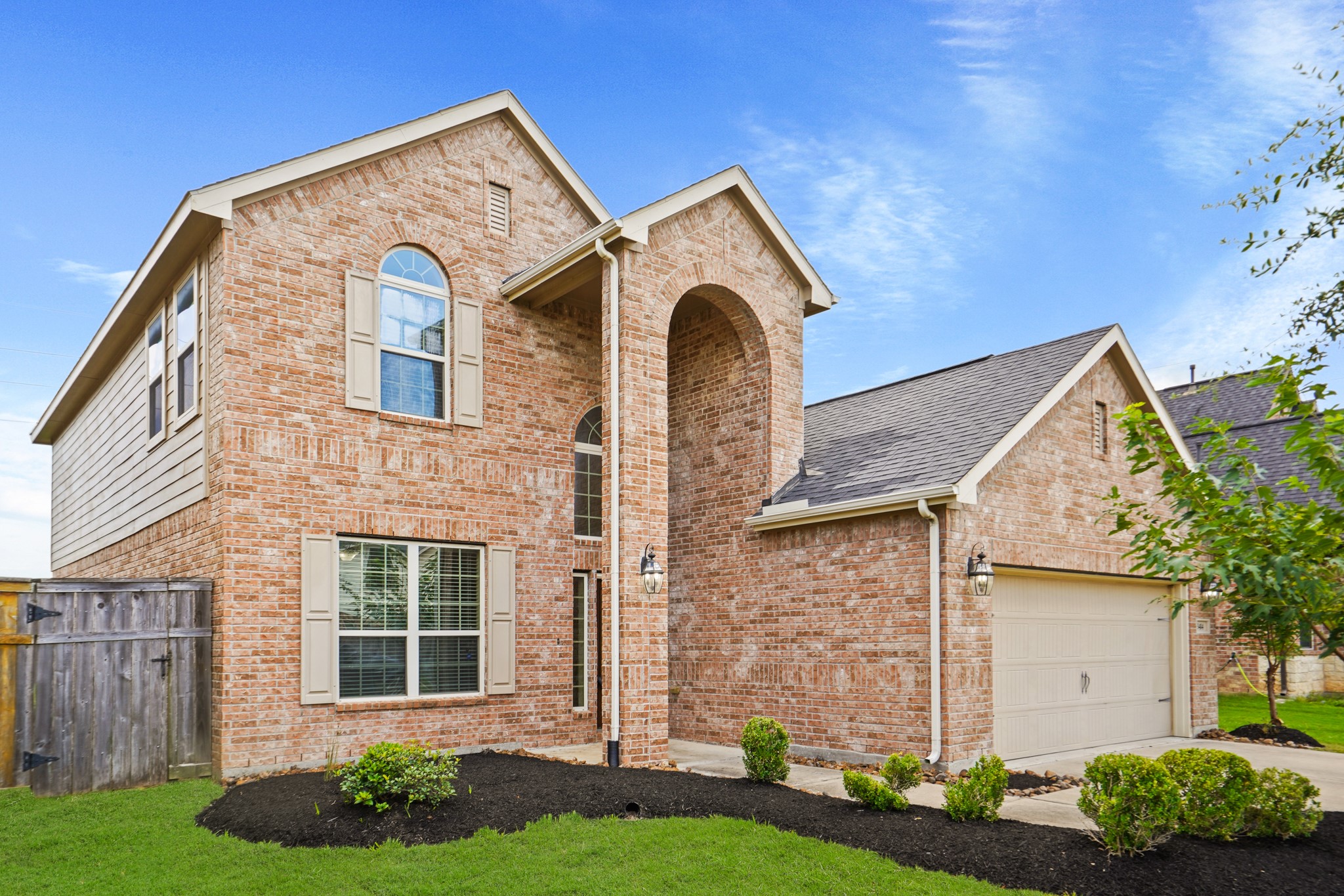 3414 Satton Ranch Lane Fulshear, TX 77441 - Photo 24 of 25 a front view of a house with a garden and plants