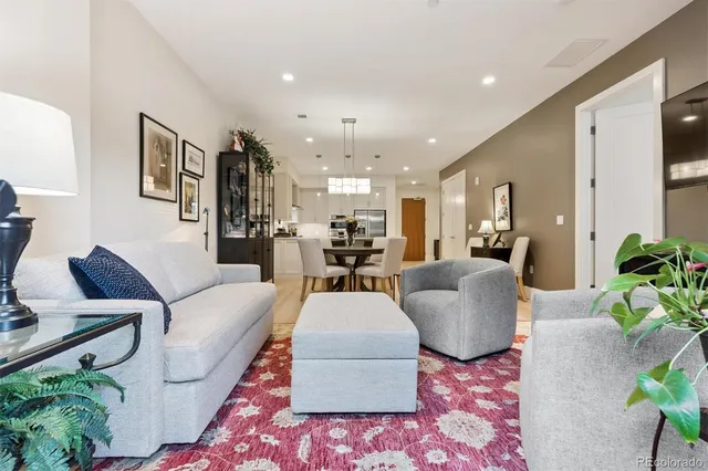 a living room with furniture and kitchen view