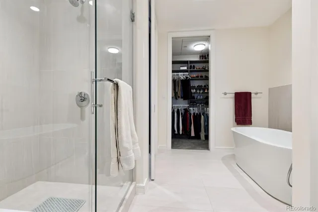 a view of a hallway with closet and a living room