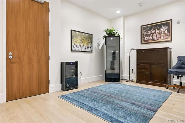 a view of a hallway with wooden floor and closet