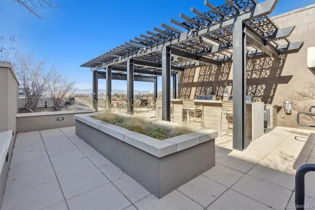a view of a patio with a table and chairs