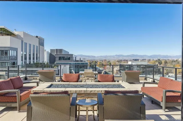 a view of a roof deck with couches and potted plants