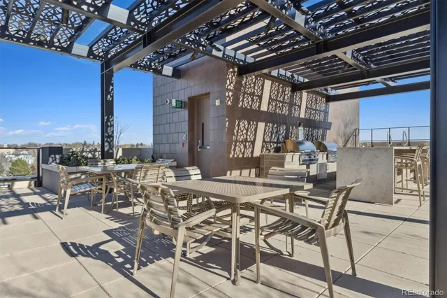 a view of roof deck with couches and potted plants