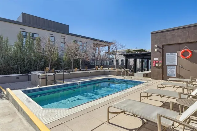 a view of a room with gym equipment and a wooden floor