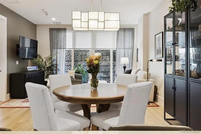 a kitchen with kitchen island a dining table and chairs