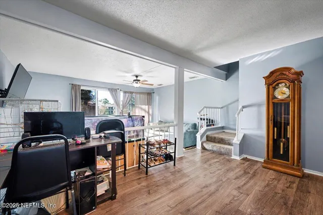 a living room with furniture and wooden floor