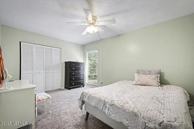 a bedroom with a bed and a television