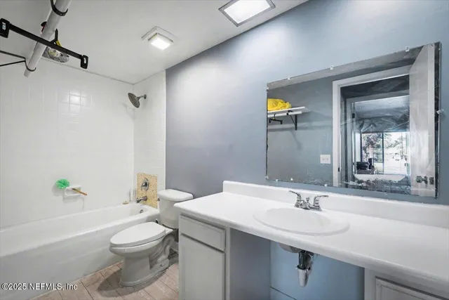 a bathroom with a toilet a sink and a bathtub