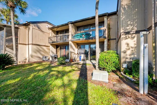 a view of a house with backyard and sitting area