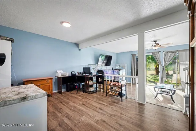a living room with furniture and wooden floor