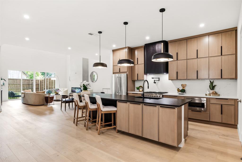 4322 Sexton Lane Dallas, TX 75229 - Photo 2 of 34 a kitchen with stainless steel appliances kitchen island a large island in the center
