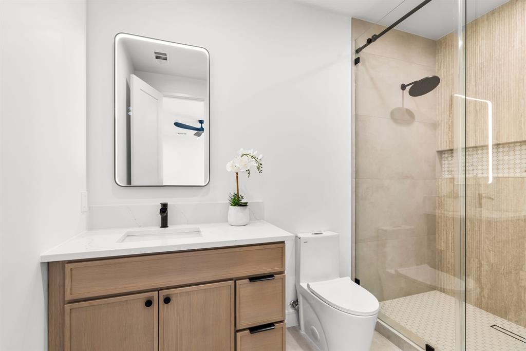 4322 Sexton Lane Dallas, TX 75229 - Photo 21 of 34 a bathroom with a sink a toilet and shower