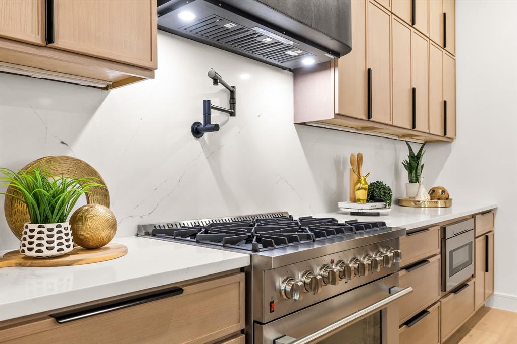 4322 Sexton Lane Dallas, TX 75229 - Photo 28 of 34 a kitchen with a stove and a white refrigerator