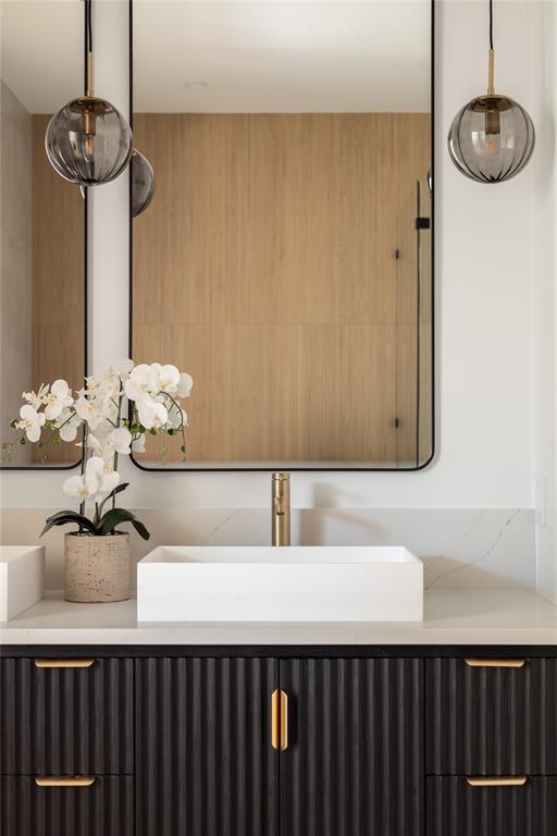 4322 Sexton Lane Dallas, TX 75229 - Photo 10 of 34 a bathroom with a sink and a mirror