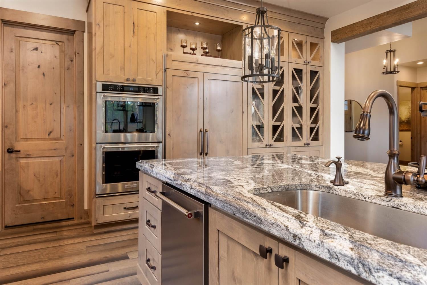 56424 Fireglass Loop Bend, OR 97707 - Photo 7 of 25 Showpiece kitchen with gleaming granite slab countertops, spacious island breakfast bar, double
ovens, gas range with 6-burner cooktop and griddle, 2-dishwashers, 2-deep sinks, cavernous
side-by-side refrigerator and freezer, walk-in pantry with built-ins and plentiful storage, this kitchen
will bring out the master chef in you.