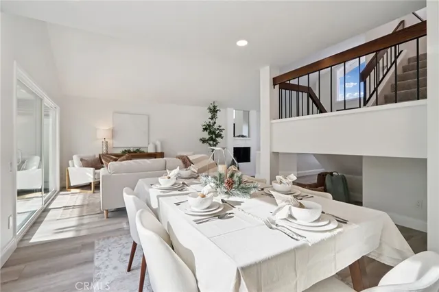 a white vase with white and yellow flowers