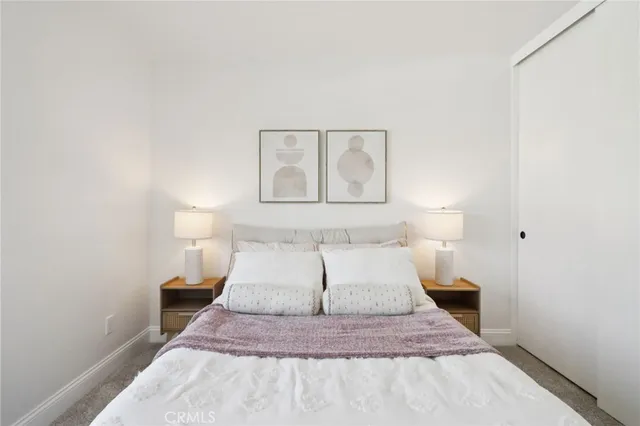 a spacious bedroom with a bed and a window