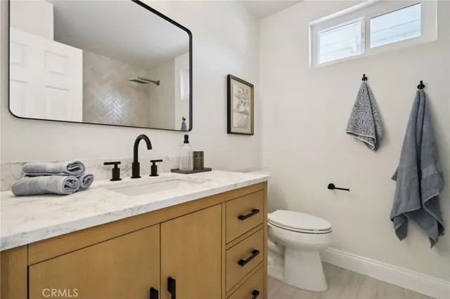 a white toilet sitting next to a bathroom sink
