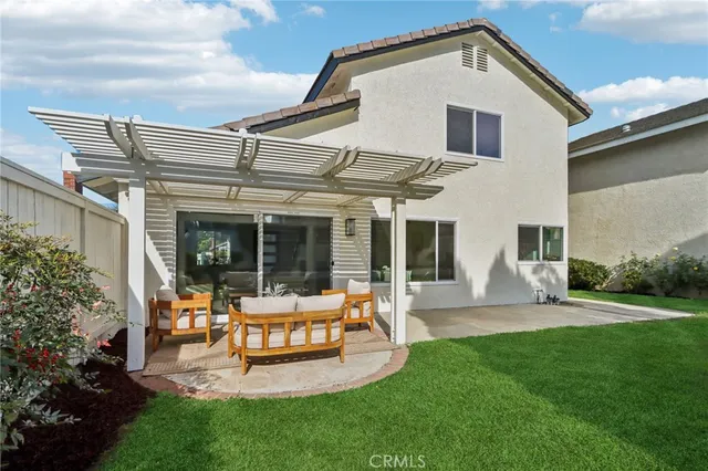 a view of a patio with table and chairs potted plants