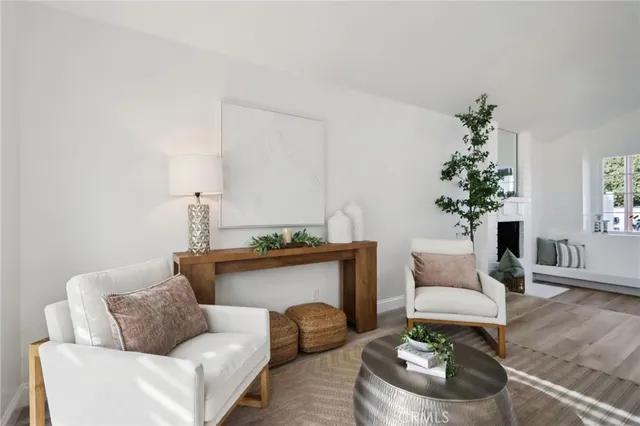 a living room with furniture and a dining table with wooden floor