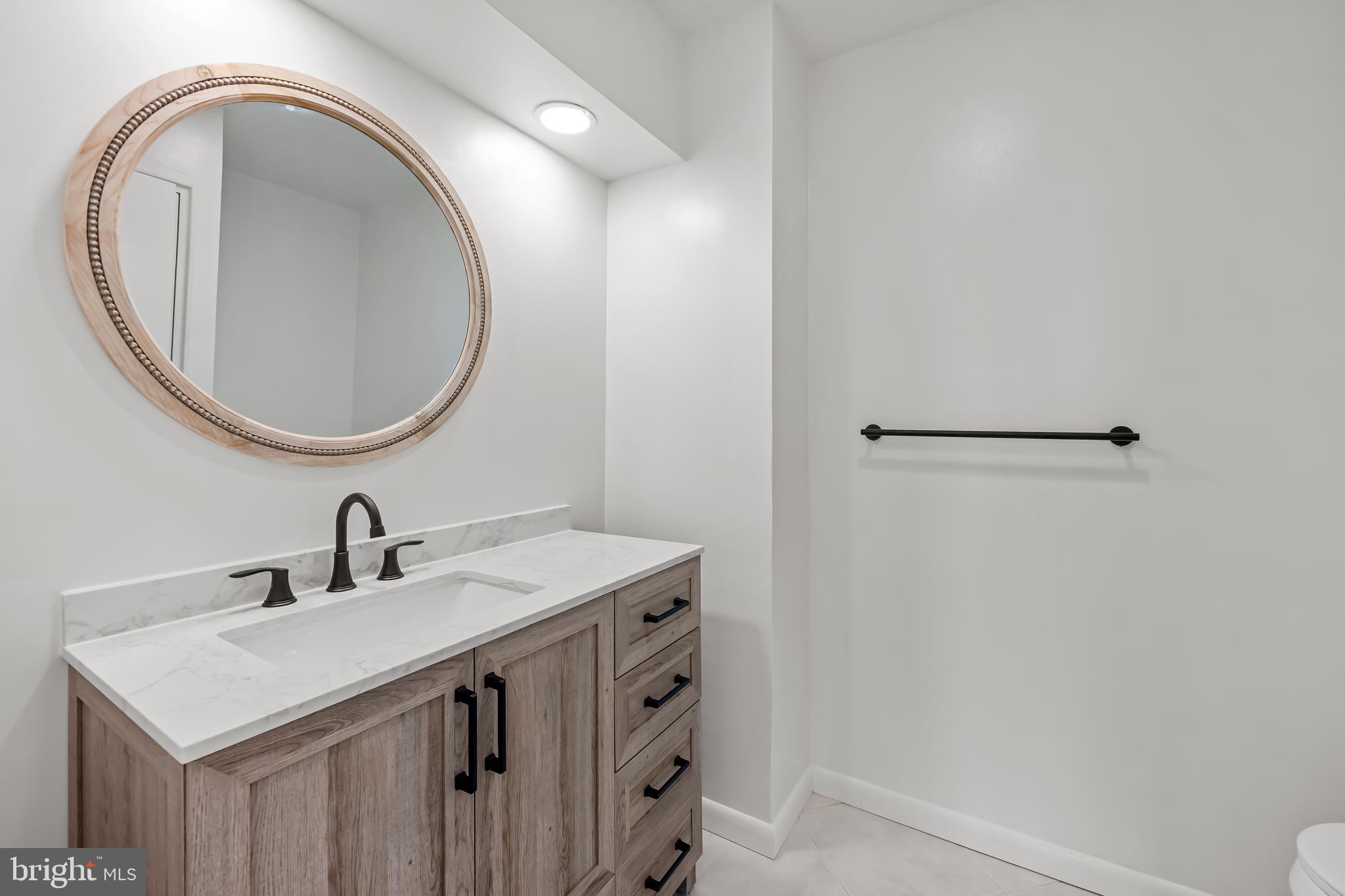 11 Slade Avenue, Unit 911 Baltimore, MD 21208 - Photo 20 of 32 a bathroom with a sink and a mirror