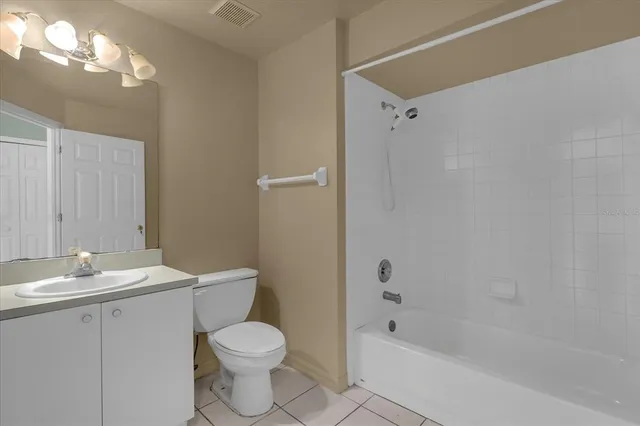 a bathroom with a bathtub shower sink vanity and toilet