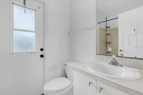 a bathroom with a sink toilet and vanity