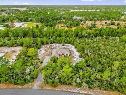 an aerial view of a house with a yard