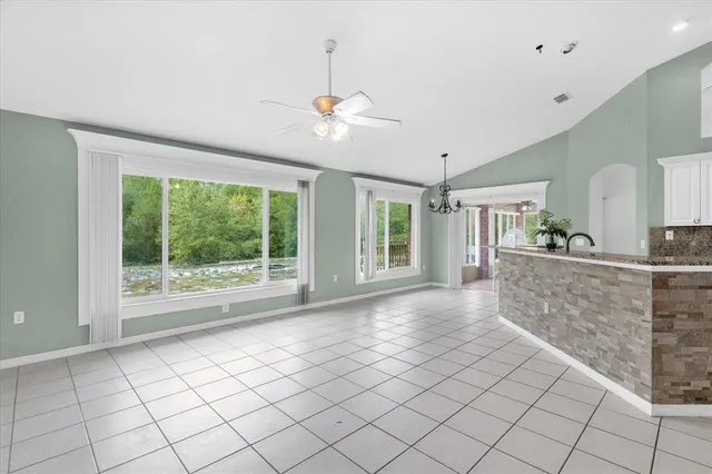 a view of an empty room with window and cabinet