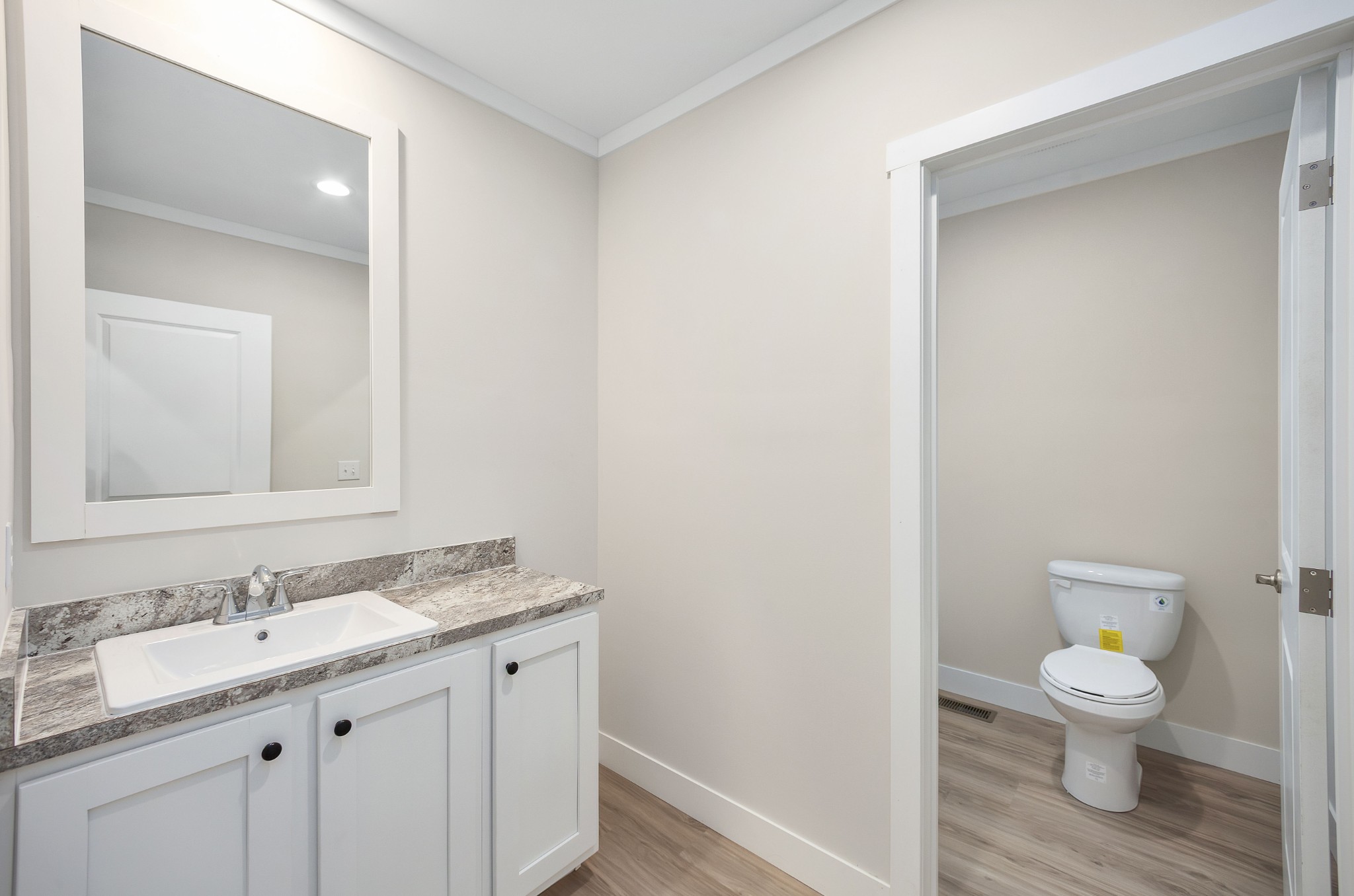 2127 North Royal Street Jackson, TN 38305 - Photo 19 of 24 a bathroom with a granite countertop sink toilet and a mirror