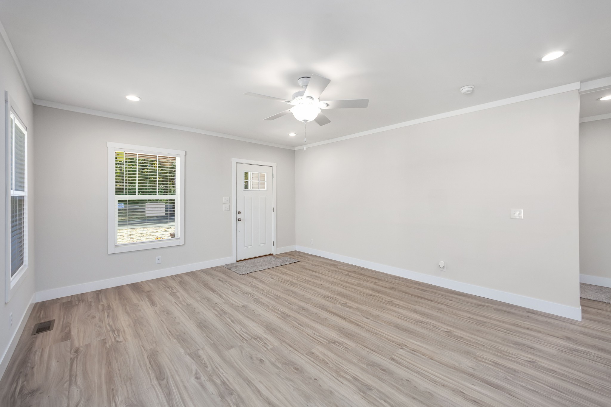 2127 North Royal Street Jackson, TN 38305 - Photo 4 of 24 wooden floor in an empty room with a window