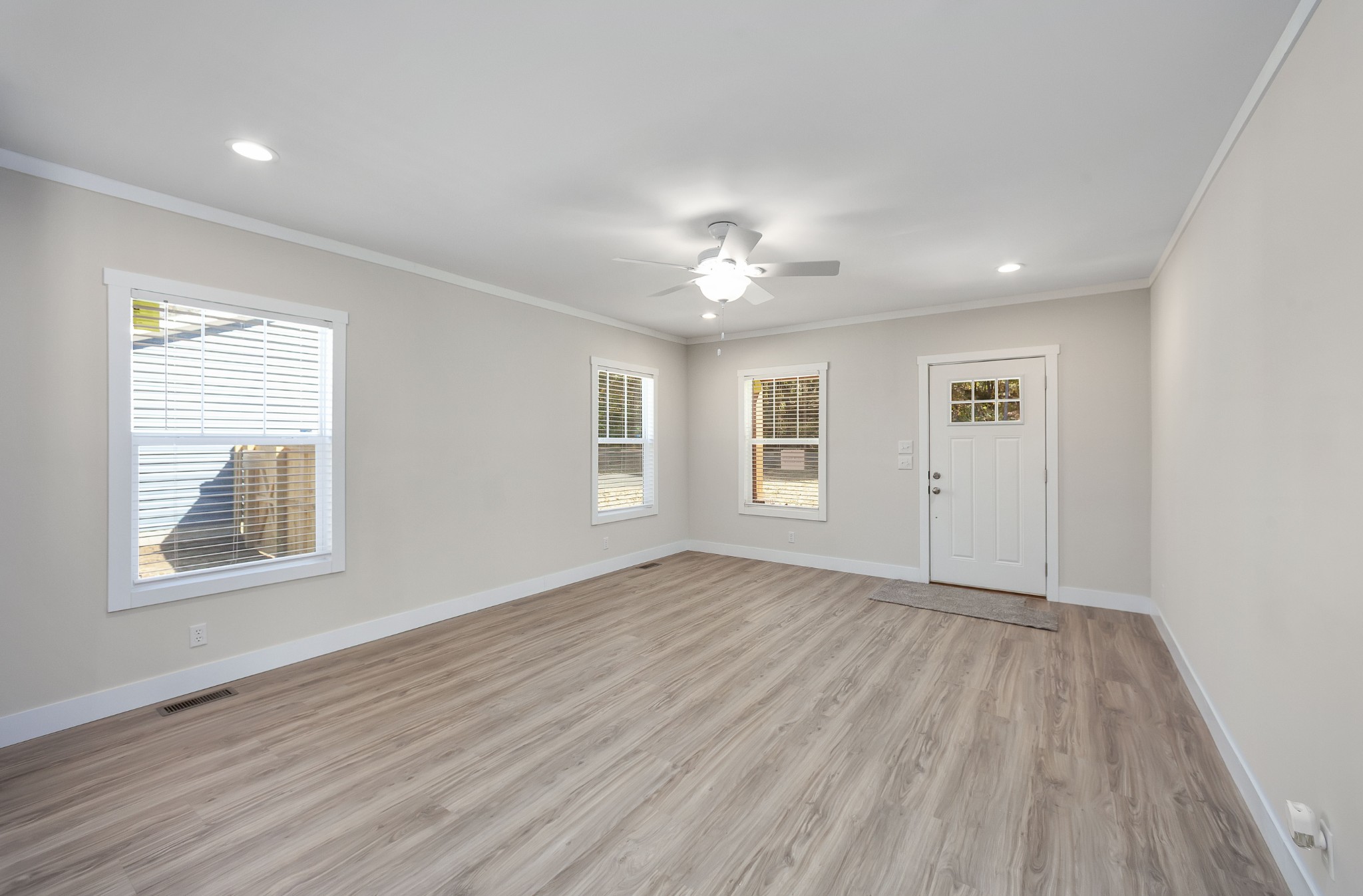 2127 North Royal Street Jackson, TN 38305 - Photo 5 of 24 a view of an empty room with a window and wooden floor