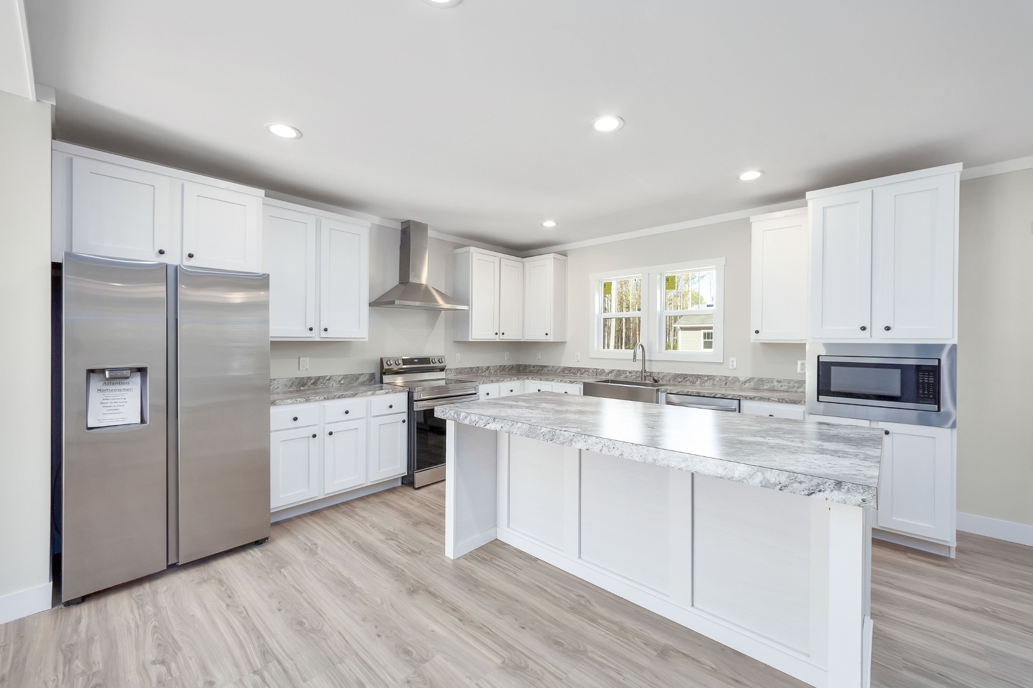 2127 North Royal Street Jackson, TN 38305 - Photo 6 of 24 a kitchen with kitchen island white cabinets and refrigerator