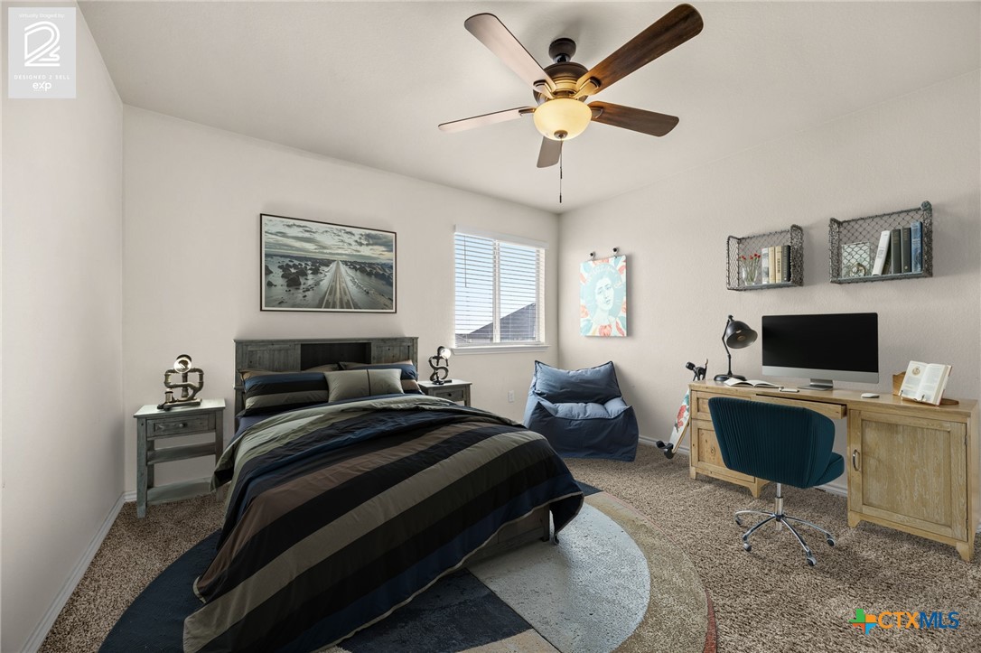 5927 Galveston Road Belton, TX 76513 - Photo 27 of 39 a bedroom with a bed a desk and chair with a bookshelf