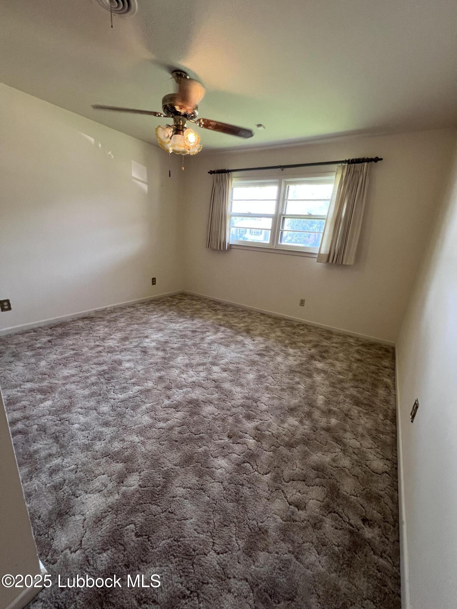 2304 54th Street Lubbock, TX 79412 - Photo 11 of 18 a view of an empty room with a window