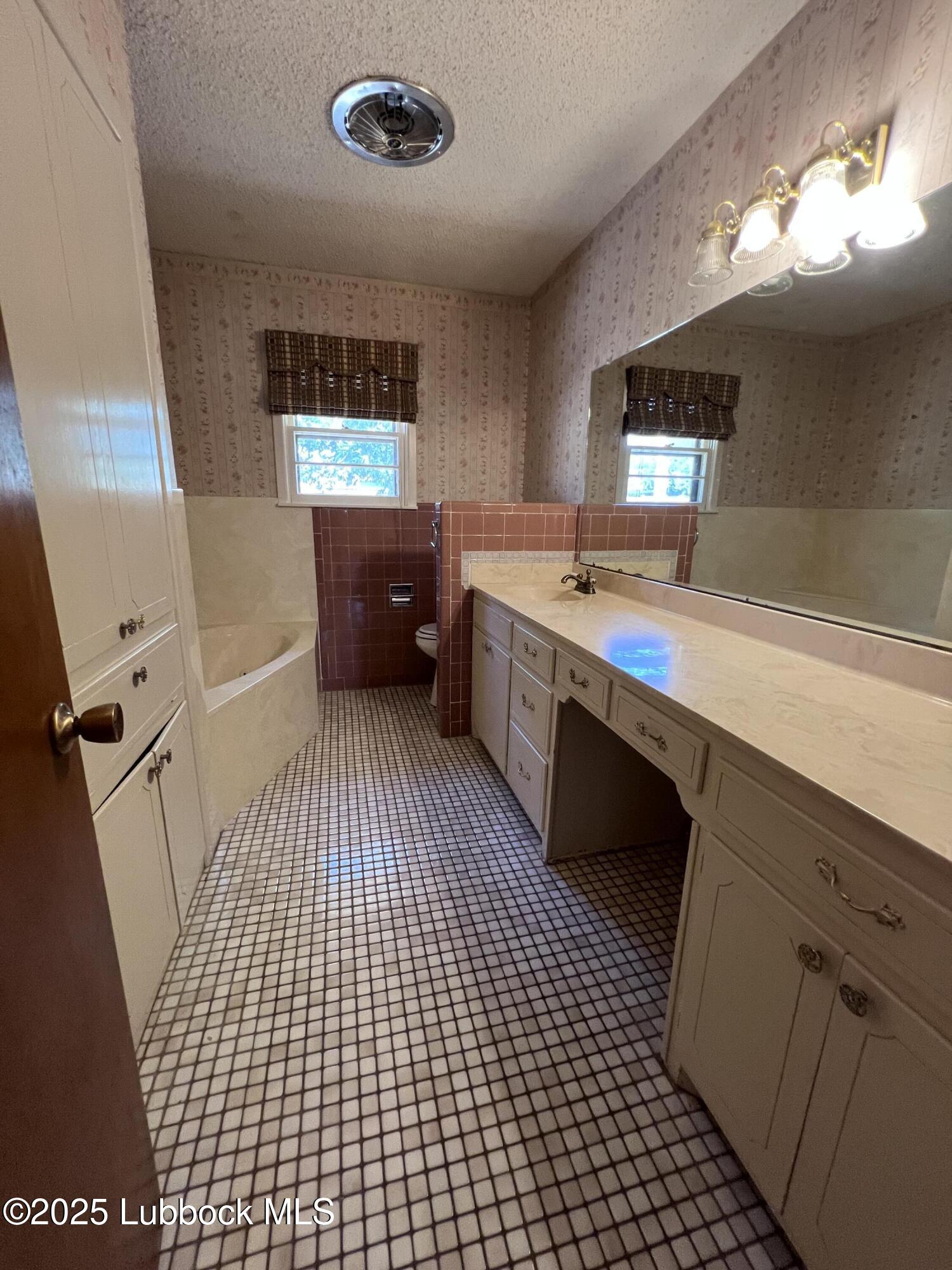 2304 54th Street Lubbock, TX 79412 - Photo 13 of 18 a room with a washing machine and sink