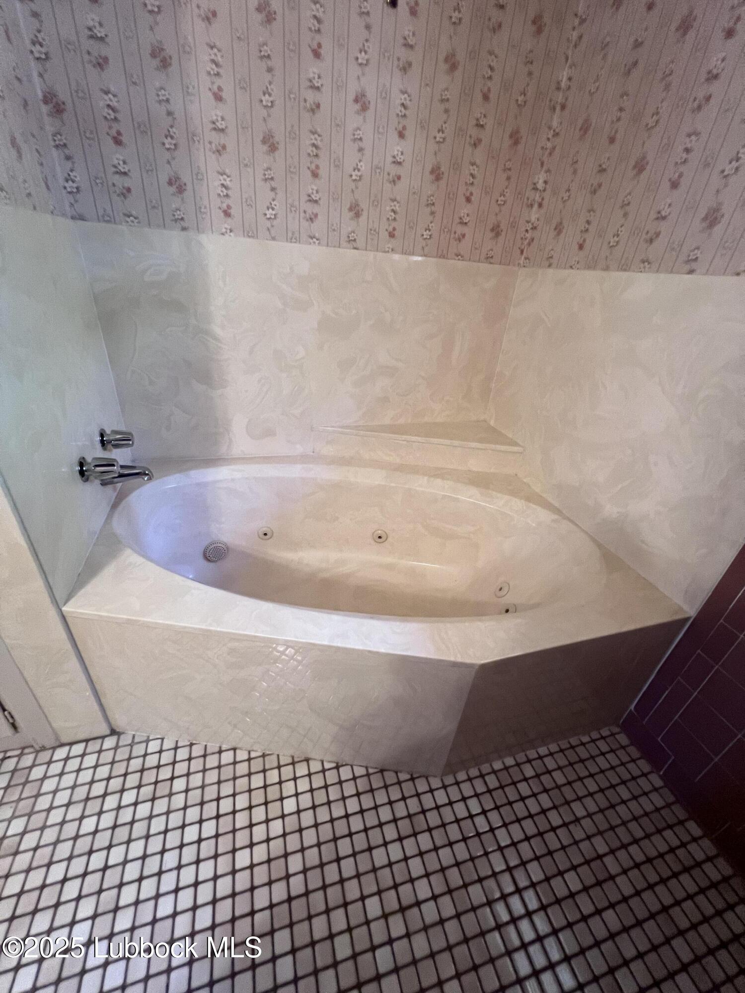 2304 54th Street Lubbock, TX 79412 - Photo 14 of 18 a view of a bathtub in a bathroom