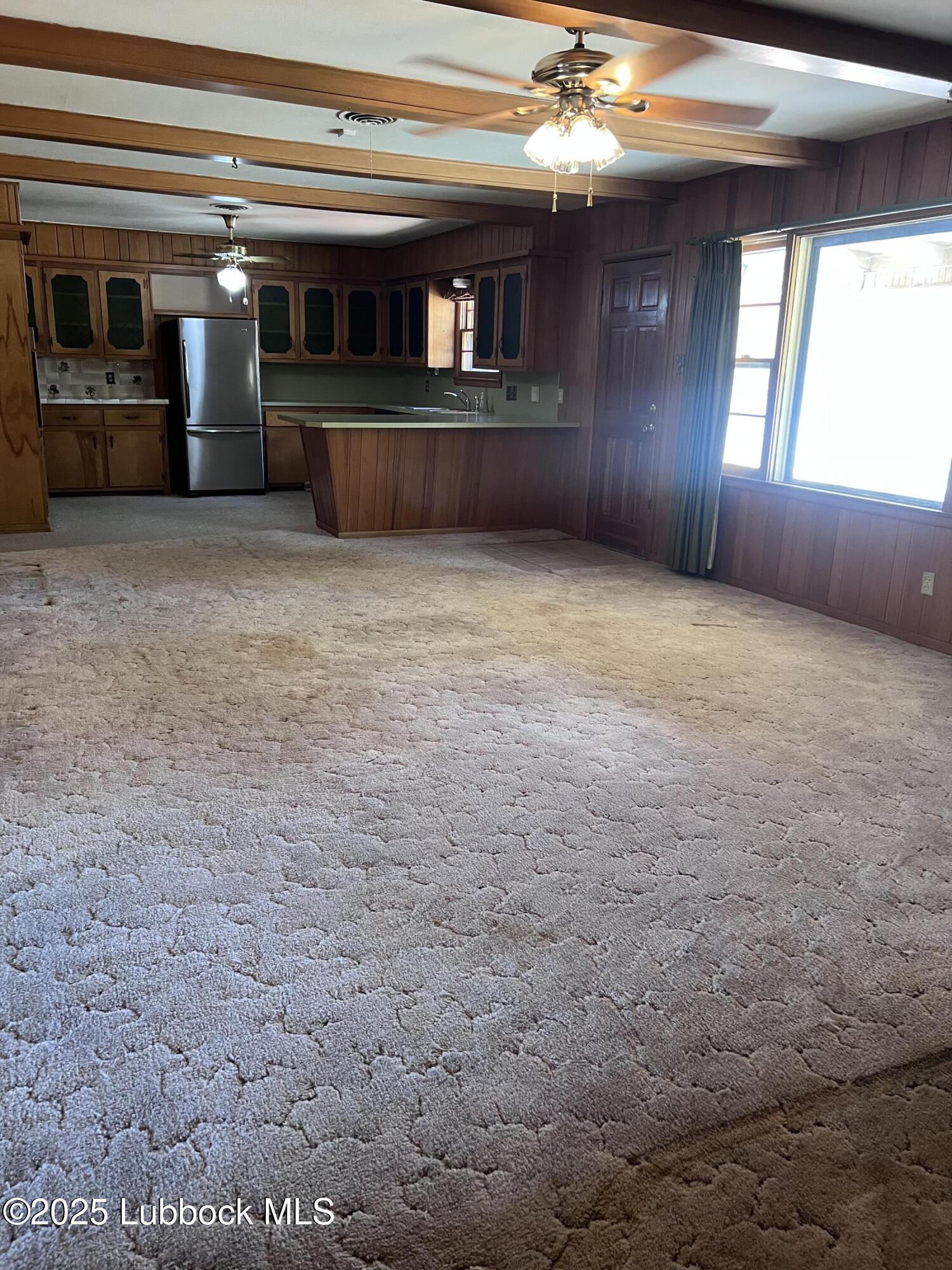2304 54th Street Lubbock, TX 79412 - Photo 6 of 18 a view of an empty room with window and fireplace