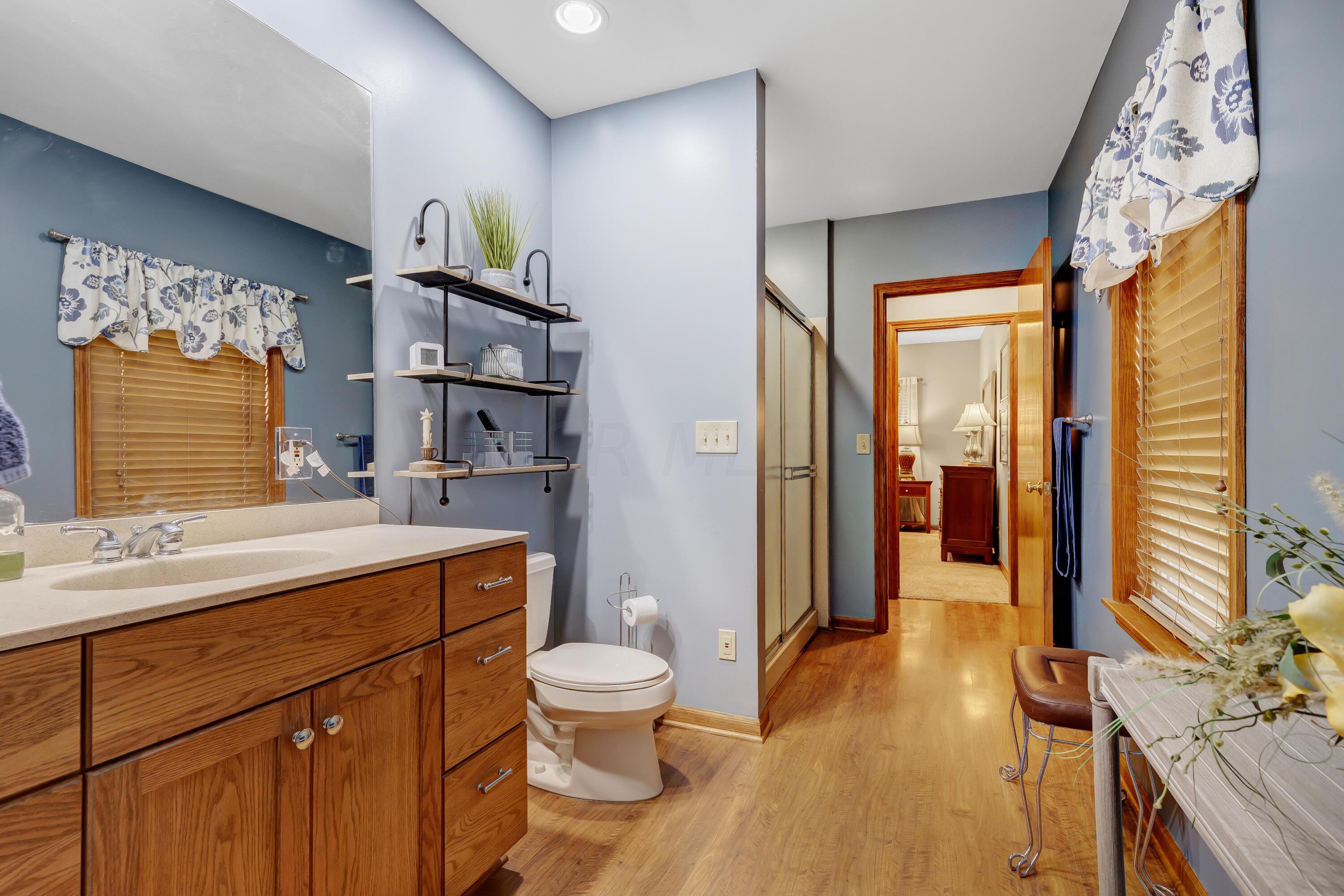 6681 Harlem Road Westerville, OH 43082 - Photo 26 of 78 • Laminate flooring • Blue painted walls • Shower stall with glass doors • Lighted ceiling exhaust • Enclosed vanity with single bowl sinktop • Can lighting • Pocket door to Hall and Laundry Room